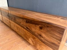 a large wooden cabinet sitting on top of a hard wood floor