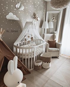 a baby's room with a teepee tent and stars on the wall