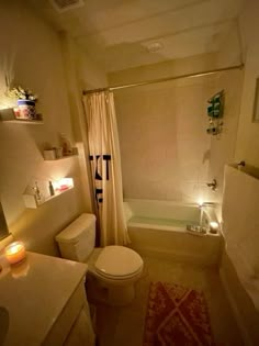 a bath room with a toilet a tub and a sink