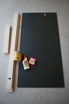 the tools needed to make a diy chalkboard art project are laid out on the floor