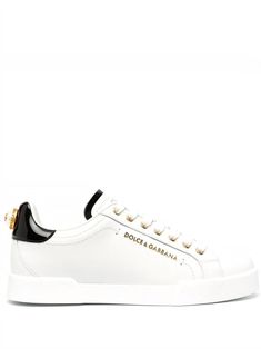 These chic sneakers are like the perfect blend of elegance and comfort wrapped up in leather and gold. They're the kind of footwear you'd wear when you want to look stylish without compromising on ease. Just slip them on and let your feet do the talking. Crafted from premium white leather Features white rubber sole for a secure grip Gold color logo lettering enhances the look Pearl effect logo application on the back Designed and made in Italy Season: FW24 Composition: 100% Leather / Rubber Sole White And Gold Sneakers, Dolce Gabbana Sneakers, Italian Luxury Brands, Gold Sneakers, Sneakers Looks, White Leather Sneakers, White Sneakers Women, Pink Sneakers, Dolce E Gabbana