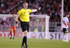 the referee is giving instructions to his players