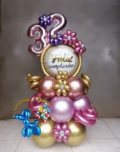 a birthday cake with balloons and decorations on it