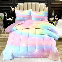 a bed room with a rainbow colored comforter and two pillows on top of it