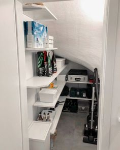 an organized pantry with white shelving and lots of storage space on the bottom shelf