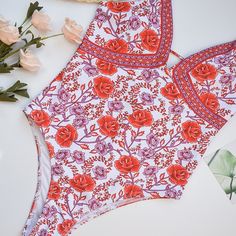 Sparkling rose all day in pretty Rosa One Piece Swimsuit. Feminine one piece swimwear features colorful flower print stretch fabric. This classic cut floral bathing suit offers the perfect amount of bottom coverage. Swim or lounge because you can enjoy it in and out of the water. Congratulations, you are one of the first to try our new swim collection! Details: Classic cut Rosa One Piece Swimsuit Bust is padded and wire free This style runs small, we recommend sizing up one full size from your t Floral Print Stretch Tankini For Sunbathing, Stretch Floral Print Tankini For Sunbathing, Beachy Swimwear With Floral Print And Stretch, Beachy Stretch Swimwear With Floral Print, Fitted Hibiscus Print Swimwear For Poolside, Summer Floral Print Sleeveless Bodysuit, Sleeveless Summer Bodysuit With Floral Print, Summer Sleeveless Floral Bodysuit, Pink Hibiscus Print Swimwear For Swimming