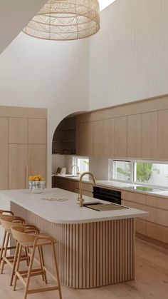 a kitchen with an island and stools in it