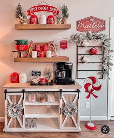 a coffee bar decorated for christmas with candy canes and other holiday decorations on shelves