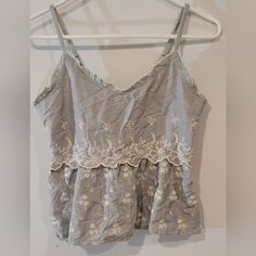 Brand New Embroidered Floral Small Size Gray Excellent Condition. No Flaws Cheap Gray Top With Embroidered Graphics, Cheap Embroidered Gray Tops, Cotton Cami Top With Floral Embroidery, Gray Embroidered Cotton Top, Fitted Embroidered Cami Top, Embroidered Cotton Cami Top, Embroidered Lace V-neck Top, Oversized Crop Top, Cutout Crop Top