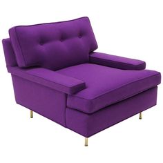 a purple couch sitting on top of a white floor