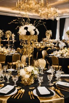 an elegant table setting with black and gold linens