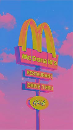 a mcdonald's restaurant and drive thru sign in front of a blue sky with clouds