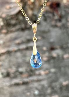 "This simple dainty necklace features a London blue topaz teardrop set in solid gold suspended from a beautiful gold filled chain. This blue topaz is very vibrant in color, London blue which makes it match multiple outfit and could be your every day necklace since it is so beautiful. This necklace is simply perfect for everyday wear and is perfect for layering with other pieces in your collection. Ideal for an anniversary gift or a December Birthday gift, or that perfect soft color earring to never take off, these crystal clear blue earrings are a forever piece of jewelry that can remain in your family for generations to come.  About This Necklace: * Stone: London Blue Topaz * Birthstone Month: December * Stone Size: 12 mm x 8 mm * Total Length: 25 mm (7/8\") * Finish: 14k Gold * Gift Wrap 14k Gold Teardrop Birthstone Necklace, Blue Teardrop Gemstone Birthstone Necklace, Elegant Blue Teardrop Birthstone Necklace, Blue Teardrop 14k Gold Necklace, Blue Briolette Drop Necklace, Yellow Gold Teardrop Blue Topaz Necklace, Gold Necklace With Faceted Blue Topaz, Gold Faceted Blue Topaz Necklaces, Light Blue Topaz Pendant Necklace