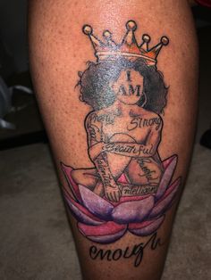 a tattoo on the leg of a woman with a crown