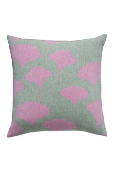 a pink and green pillow on a white background with an image of flowers in the middle