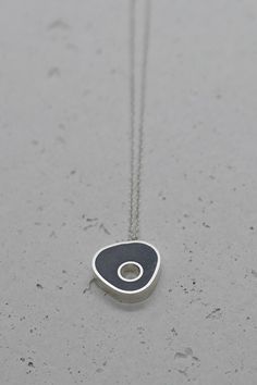 Tiny asymmetrical necklace is handmade of sterling silver frame filled with dark gray resin & concrete mix.                                                                                                                                                                                Concrete has slightly rough natural texture and matte finish.                                                                                                             Measurements: Pendant Size: 14 mm / 0.55 inch Minimalist Silver Necklace, Resin Concrete, Concrete Necklace, Minimalist Necklace Silver, Asymmetrical Necklace, Gift For Architect, Concrete Pendant, Mix Concrete, Necklace Resin