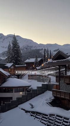 the mountains are covered in snow at dusk