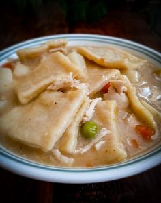 a white plate topped with dumplings and vegetables