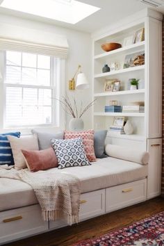 a living room filled with lots of white furniture