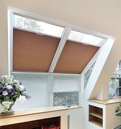 a room that has some shelves with vases and flowers on them in front of the window