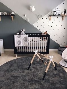 a baby's room is decorated in black and white