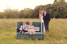 two children sitting on a couch with a sign that says 10 years later in front of them