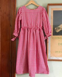 This dress is lovingly handmade by myself in my home studio in west wales.It’s a loose smock style which you put on over the head, it has a high gathered waist line, mid length sleeves with pretty tie detail and side pockets. All my items are made using french seams for longevity and a professional finish.The fabric is yarn dyed gingham, 100% cotton. This means that each strand is dyed prior to weaving, this gives the fabric a quality feel and a beautiful finish.  Because of the nature of the fa Green Gingham Dress, Red Gingham Dress, Midi Skirt With Pockets, Dungaree Dress, West Wales, Mid Length Sleeves, Gingham Fabric, Green Mini Dress, Bridesmaid Outfit