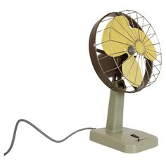 a yellow fan sitting on top of a metal stand