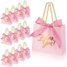 pink and gold gift bags with thank you written on them