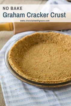 a pie crust in a glass dish with a rolling pin on the table next to it