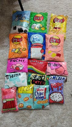 a pile of candy bags sitting on top of a floor next to a carpeted floor