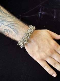 This stainless steel chainmaille bracelet is hand woven using 100% stainless steel rings. Stainless is hypoallergenic, strong, non-corrosive and very long lasting with easy maintenance.  Stainless does not tarnish or rust, making it perfect for continuous wear. It's also perfect for those with sensitivities to nickel.   MEASURES  7'.5" Inches (adjustable to 9'')   19 cm (adjustable to 22.'5 cm)  THIS ITEM IS MADE TO ORDER   Expect 4-6 weeks before shipping. You will essentially be skipping the line, without having to wait for scheduled restocks that may sell out.  If you need a custom size, please include your measurements in the notes.  Handmade Disclaimer   Each piece is handmade by me. Therefore there may be slight, nearly undetectable differences to the pictured piece. This might be sl Adjustable Chainmail Chain Bracelet, Silver Chainmail Chain Link Bracelets, Silver Chainmail Bracelet With Chain Link, Stainless Steel Chainmail Bracelet As Gift, Metal Chainmail Bracelet, Adjustable Chainmail Chain Bracelet As A Gift, Silver Chainmail Stainless Steel Chain Bracelet, Silver Stainless Steel Chainmail Bracelet, Chainmail Bracelet