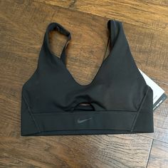 Brand New With Tags Adjustable Straps Removable Pads Medium Support Black Sports Bra With Built-in Padding For Training, Black Sports Bra With Built-in Padding, Nike Activewear With Built-in Bra For Workout, Nike Solid Sports Bra For Sports, Nike Solid Color Sports Bra, Black Go-dry Sports Bra, Nike Activewear With Built-in Bra And Medium Support, Nike Black Sports Bra For Sports Events, Casual Black Sports Bra With Light Support