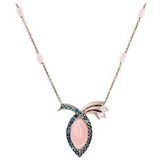 11.89 Carat Peruvian Pink Opal Blue Sapphire Pendant Necklace, In Stock. This pendant necklace features a high dome marquise cut pink opal that is 11.898 carats. It is surrounded by round brilliant-cut blue sapphires that have a 2.53-carat total weight. On the necklace chain, there are six custom-cut Peruvian opal beads with a 5-carat total weight. All of the stones in this necklace are natural stones. The opals in this necklace were cut by the award-winning cutter, Darryl Alexander. The necklace is 17 inches long and the pendant medallion is 1.38 inches long by 1.25 inches wide. The metal in the pendant necklace is palladium. This opal pendant necklace is a one-of-one jewelry design by the award-winning art jewelry designer Brenda Smith. Her work has been on the Red Carpet and in the Smit Sapphire Pendant Necklace, Blue Sapphire Pendant, Sapphire Necklace Pendants, Opal Pendant Necklace, Peruvian Opal, Opal Beads, Sapphire Pendant, Creating Jewelry, Opal Pendants