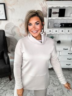 Slip into this cozy cowlneck top and you'll instantly be wrapped in softness. Lovingly crafted from a modal feel blend, this tunic feels like your favorite well-worn sweatshirt but looks polished enough for a night out. With a relaxed, flowy fit, side slits and long sleeves to keep you cozy, this top moves with you from couch to cocktails. The dramatic cowl neckline adds stylish drape and an alluring touch, perfect for showing off a statement necklace. Whether you're winding down on the weekend Funnel Neck Soft Knit Tops For Layering, Relaxed Fit Soft Knit Funnel Neck Top, Cozy Soft Knit Funnel Neck Top, Cozy Stretch Top With Funnel Neck, Chic Cowl Neck Top, Chic High Neck Loungewear Top, Chic High Neck Tops For Loungewear, Fall Layering Tops With Cowl Neck, Cozy Funnel Neck Spring Top