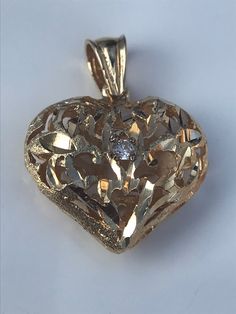 Large 14 k gold heart with center diamond Puffy style with 2.5 mm diamond center, bright cut design Beautiful stand alone or wear with other pendants 1 inch long 3/4 inch across 7 mm deep7x4 bail Weight 1.8 dwt Gold Heart Jewelry With Diamond Accents, Gold Jewelry With Diamond Accents And Open Heart Shape, Gold Jewelry With Heart Detail For Anniversary, Yellow Gold Heart Necklace With Diamond Cut, Gold Jewelry With Diamond Accents In Open Heart Shape, Gold Heart Cut Jewelry With Heart Detail, Gold Heart Cut Necklace With Diamond Accents, Gold Open Heart Jewelry With Diamond Accents, Gold Double Heart Necklace With Diamond Accents