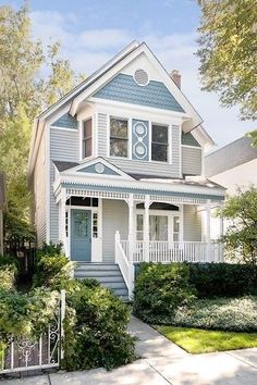 a white house with blue trim on the front