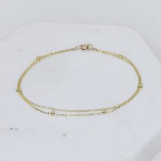 "14K Gold Dainty Multi Chain Bracelet - 14K Gold Double Chain Bracelet - 14K Solid Gold Bracelet ★ The chains and all components are 14K solid yellow gold ★ The tiny round beads are 1.7mm The length includes the chain and the closure. Please measure your wrist before you place your order. ** How to choose a correct size of bracelet. 1. Measure your wrist below the wrist bone using a flexible tape measures, a string or a strip of paper. 2. If using a string or a strip of paper, mark length. Then, Gold Double Chain Bracelet For Formal Occasions, Gold Bracelet With Delicate Chain For Formal Occasions, Dainty Gold Sterling Silver Bracelet For Formal Occasions, Elegant Gold Bracelet With Double Chain, Gold Double Strand Chain Bracelet As Gift, Gold Double Strand Bracelet With Delicate Chain, Gold Double Strand Chain Bracelet For Gift, Gold Double Band Bracelets For Formal Occasions, Gold Double Strand Bracelet For Formal Occasions