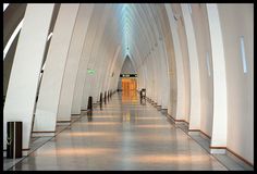 a long hallway with white walls and columns