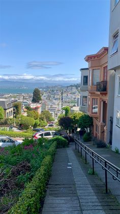 a view of a city from the top of a hill with stairs leading up to it