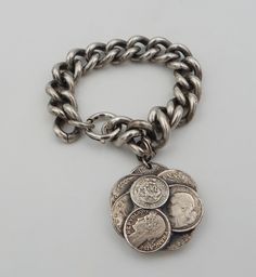 a bunch of coins sitting on top of a chain