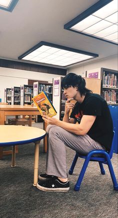 a man sitting in a chair reading a book