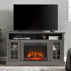 an entertainment center with a fireplace and television