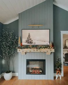 a living room with a fireplace and christmas decorations