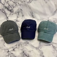 These are not cheap hats! These hats have thick, garment dyed fabric and leather buckles with quality embroidery. Each hat is custom made with your selections in Memphis by me. If you have a request for a design or want a different saying on the hat or would like the "dad" bigger or smaller, please send me a message and we can get started on a custom order! >> Hat Details << ■100% garment-washed cotton  ■Leather strap with antiqued brass buckle ■6-panel, unstructured, low-profile ■Tuck-away leather back strap ■Cool-Crown™ mesh lining >> Pictured is the charcoal hat with white thread color << Adjustable Dad Hat For Father's Day, Father's Day Cotton Hat With Curved Bill, Customizable Casual Dad Hat With Adjustable Fit, Casual Dad Hat With Curved Brim For Father's Day, Customizable Adjustable Casual Dad Hat, Customizable Casual Adjustable Dad Hat, Cotton Hat With Curved Brim For Father's Day, Casual Flat Bill Hat Gift, Father's Day Hats With Letter Print