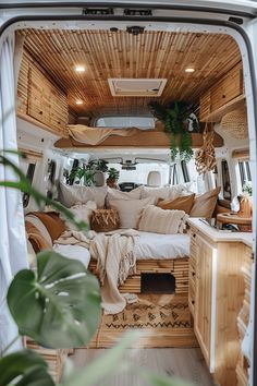 the interior of an rv with wooden furniture and plants