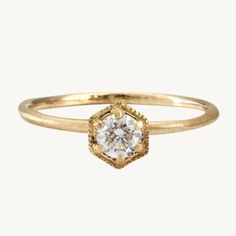 a gold ring with a diamond in the center