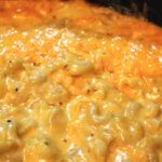 macaroni and cheese is being cooked in an oven