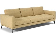 a beige couch sitting on top of a white floor