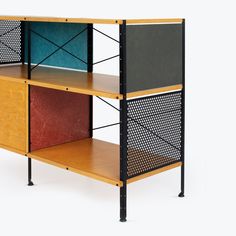 a bookcase with three different colored sections on each shelf and one black section at the top